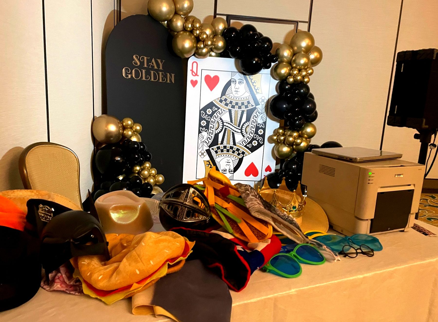 Prop table and balloon backdrop at a themed party